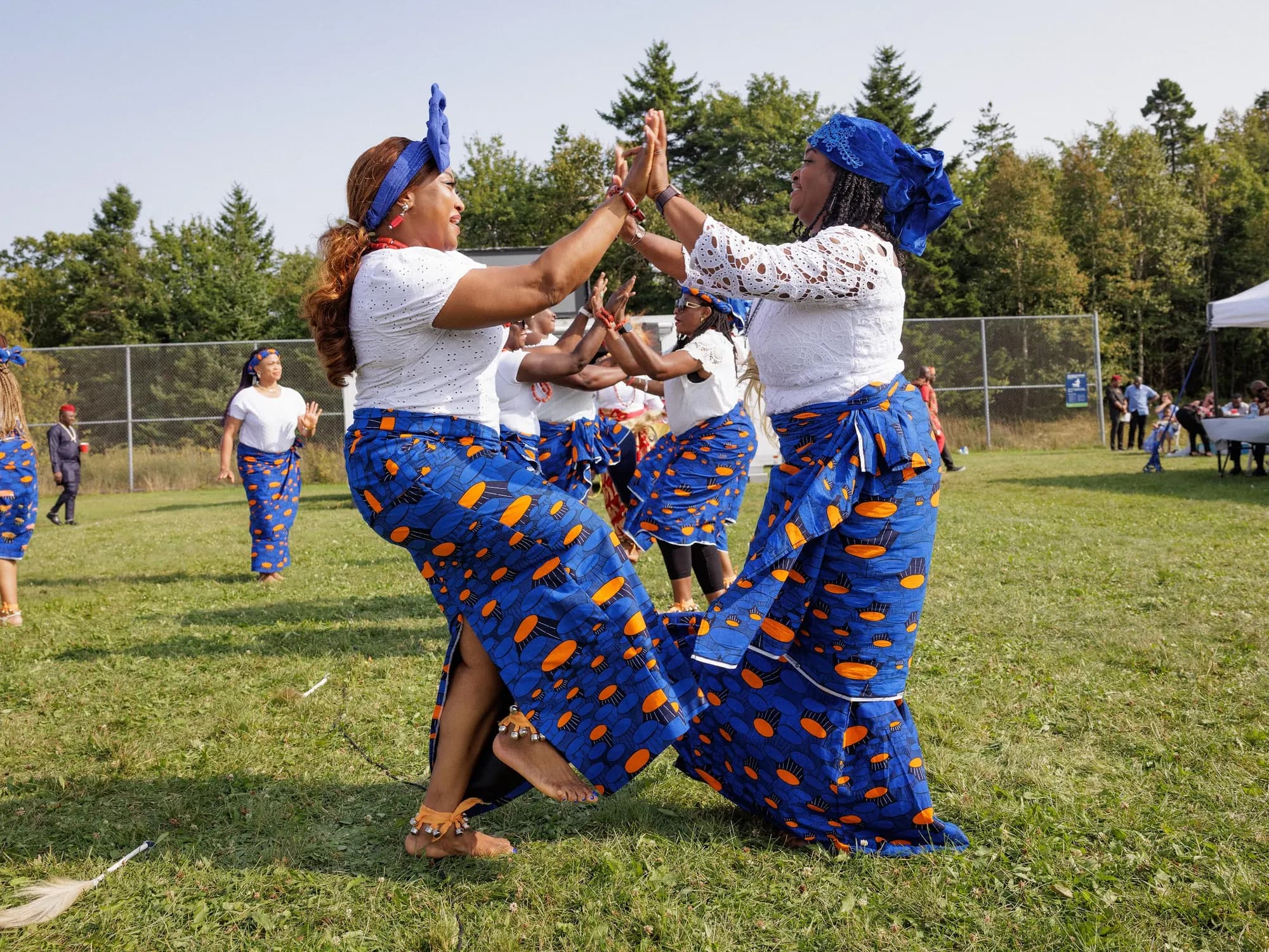 Women dancing in blue George wrappers at IRI-JI